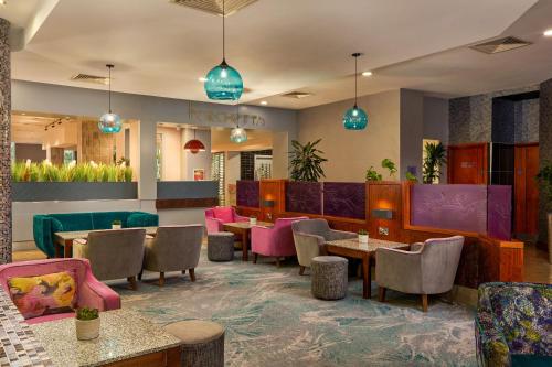a restaurant with tables and chairs and blue lights at Crowne Plaza Dublin Blanchardstown by IHG in Blanchardstown