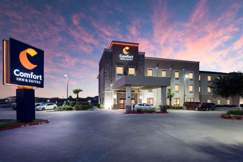 a building with a sign in a parking lot at Comfort Inn & Suites Victoria North in Victoria