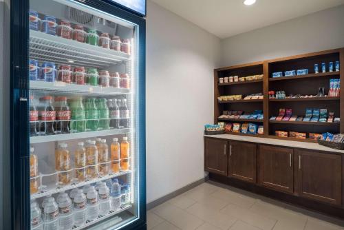 a refrigerator filled with lots of different types of drinks at Comfort Inn & Suites Victoria North in Victoria