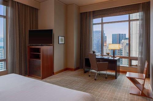 a hotel room with a desk and a television at Grand Hyatt Seattle in Seattle