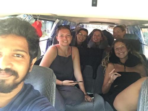 a group of people sitting in the back of a van at location weligama in Weligama