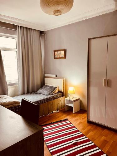 a small bedroom with a bed and a window at A cozy room in Istanbul