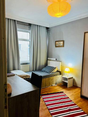 a small room with two beds and a window at A cozy room in Istanbul