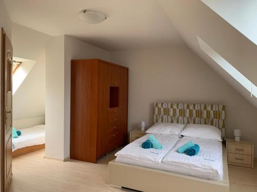 a bedroom with a bed with blue towels on it at Apartamenty Staromłyńska in Szczecin