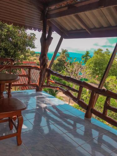 a porch with a view of the ocean at Tanouy Garden in Baan Khai