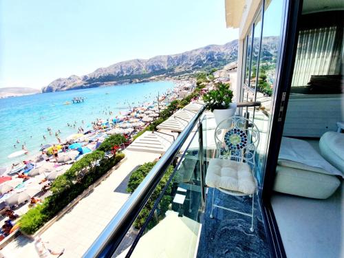 a balcony with a view of a beach and the ocean at Apartments Toni in Baška