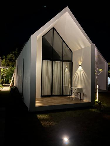 a small house with a large window at night at Ezu Isle Langkawi Pool Villa in Pantai Cenang