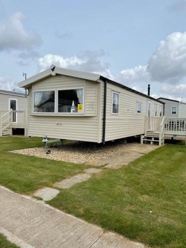a mobile home is parked in a yard at Beautiful Butlins van in Lincolnshire