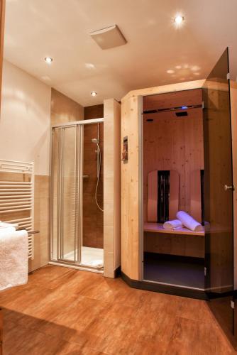 a bathroom with a shower and a glass shower stall at Apart Sattelkopf in Fiss