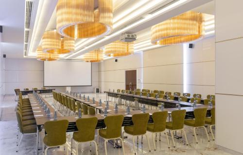 a conference room with a long table and chairs at Pyramid Continental Hotel in Juba