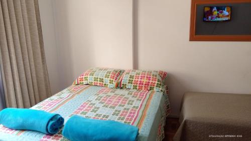 a small bed with two pillows on top of it at FLAT 201 in Petrópolis