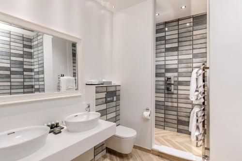 a white bathroom with two sinks and a shower at South Lodge in Lower Beeding
