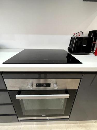 a counter top with a stove top oven in a kitchen at Brand new Appartement of two bedrooms in Sliema in Sliema