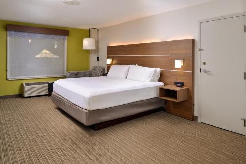 a hotel room with a large bed and a window at Holiday Inn Express Blowing Rock South, an IHG Hotel in Blowing Rock