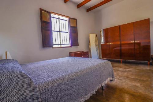 a bedroom with a bed and a window at Rentaliday Casa Saro in Arona