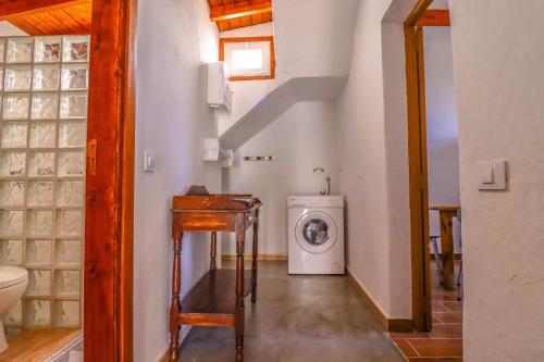 a bathroom with a washer and dryer in a room at Rentaliday Casa Saro in Arona