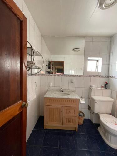 a bathroom with a sink and a toilet at El Centrito in Talca