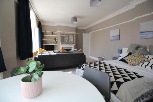um quarto com 2 camas e um sofá em Pier View Studio Apartment em Cowes