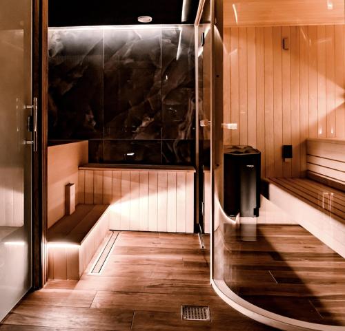 a sauna with wooden floors and a glass wall at Stables Ashbourne in Ashbourne