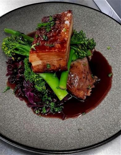 a plate of food with meat and vegetables on a plate at St. Davids Cross Hotel in St. Davids