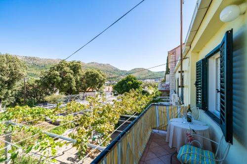 a balcony of a building with a table and chairs at Apartments Lidija in Zaton