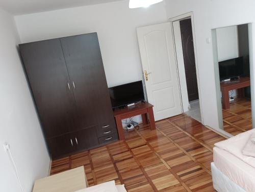 a living room with a large black cabinet and a television at Апартамент Ели in Veliko Tŭrnovo