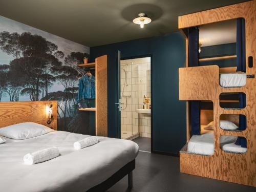 a bedroom with two bunk beds and a bathroom at Eklo Toulouse in Toulouse