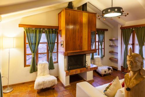 a living room with a couch and a fireplace at Quinua Boutique Apartments in Cusco