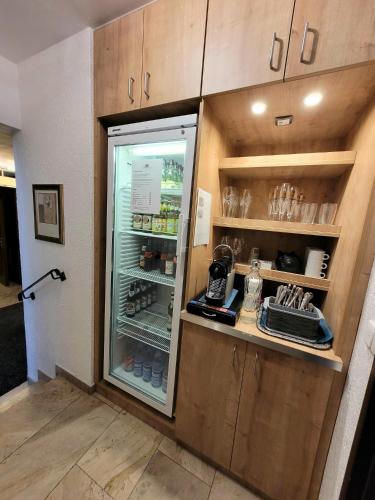 a kitchen with a refrigerator with drinks in it at Dreispitz -B&B-Hotel Garni in Hofheim am Taunus