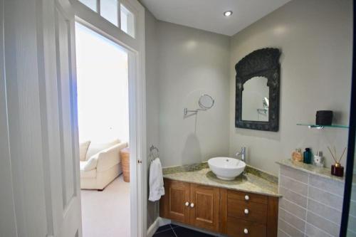a bathroom with a sink and a mirror at Albion House in Deal