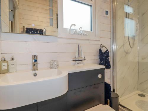 a bathroom with a sink and a shower at St Chad's Lodge in Luxulyan