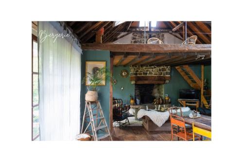 a living room with a table and a fireplace at Refuge Out of the City in Arudy