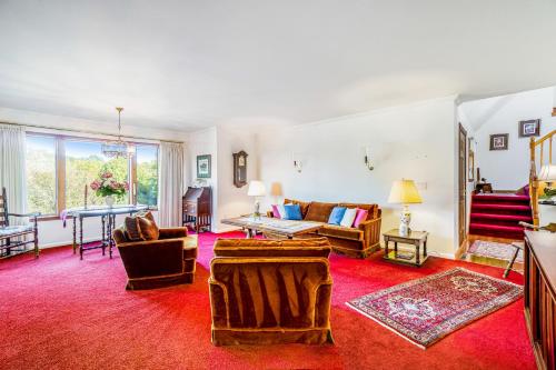 a living room filled with furniture and a red rug at Hidden Gem in Arcadia