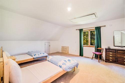 a bedroom with two beds and a dresser at Hidden Gem in Arcadia