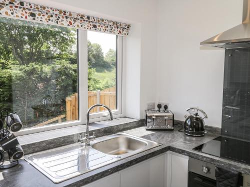 a kitchen with a sink and a window at Foulsyke Farm Bungalow in Saltburn-by-the-Sea