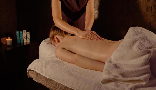 a woman giving a man a massage in a towel at Springfield Hotel & Health Club in Halkyn