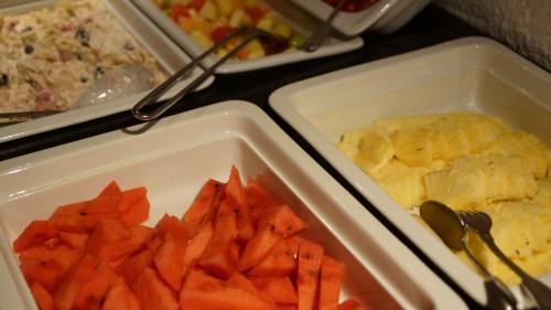two containers of food with carrots and other foods at Posthotel Rössli in Gstaad