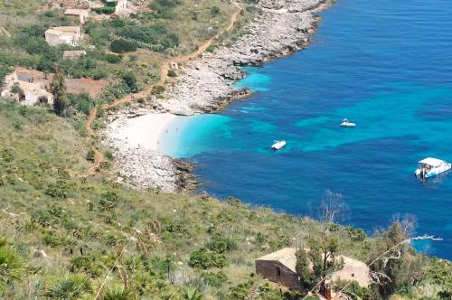 a view of a beach with two boats in the water at B&B La mia Isola in Castelluzzo