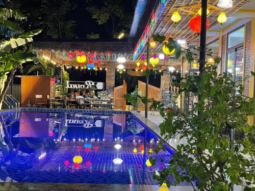 a pool in a restaurant with colorful lights at Ninh Binh Royal Homestay in Ninh Binh
