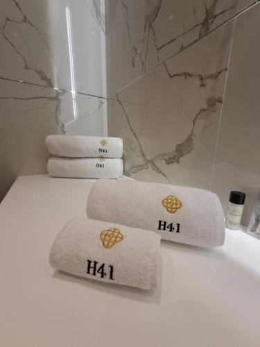 a pile of towels sitting on top of a bath tub at H41 Luxury Suites in Belgrade