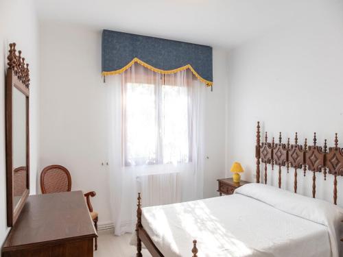 Schlafzimmer mit einem Bett, einem Schreibtisch und einem Fenster in der Unterkunft Charming holiday home in Sanxenxo with private terrace in Sanxenxo