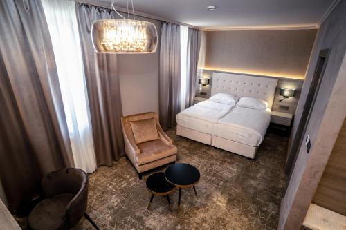 a living room with a white couch and a chair at HOTEL EUROPA in Komárno