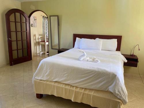 a bedroom with a large white bed with a swan on it at El Cabarete Spa Resort all-Inclusive in Cabarete