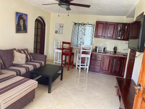 a living room with a couch and a kitchen at El Cabarete Spa Resort all-Inclusive in Cabarete