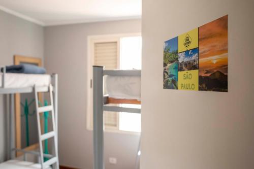 a room with two bunk beds and a poster on the wall at Casa Ecotrips Barra Funda - Hostel in Sao Paulo