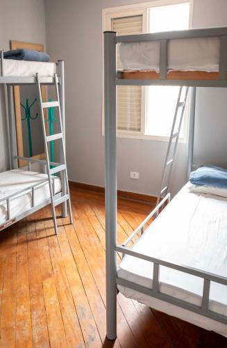 two bunk beds in a room with a wooden floor at Casa Ecotrips Barra Funda - Hostel in Sao Paulo