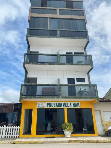 a tall building with a store in front of it at Pousada Vela Mar in Maragogi