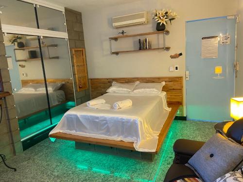 a bedroom with a bed and a large mirror at Apart Hotel Seg Total Lofts Encantadores in Mogi-Guaçu