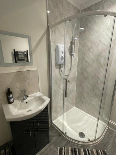 a bathroom with a shower and a sink at The Up And Over in Northallerton