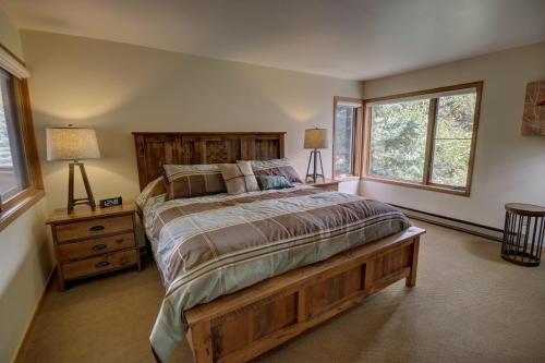 a bedroom with a large bed and two windows at Ski Run 201 in Keystone